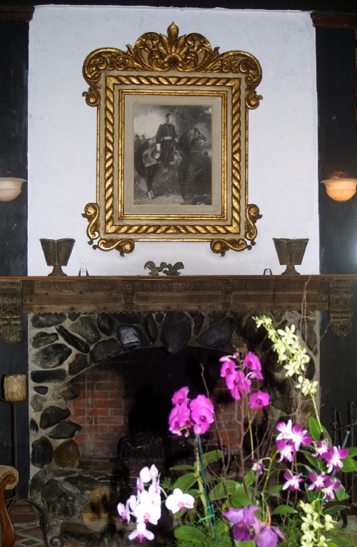 Portrait of Greg above fireplace